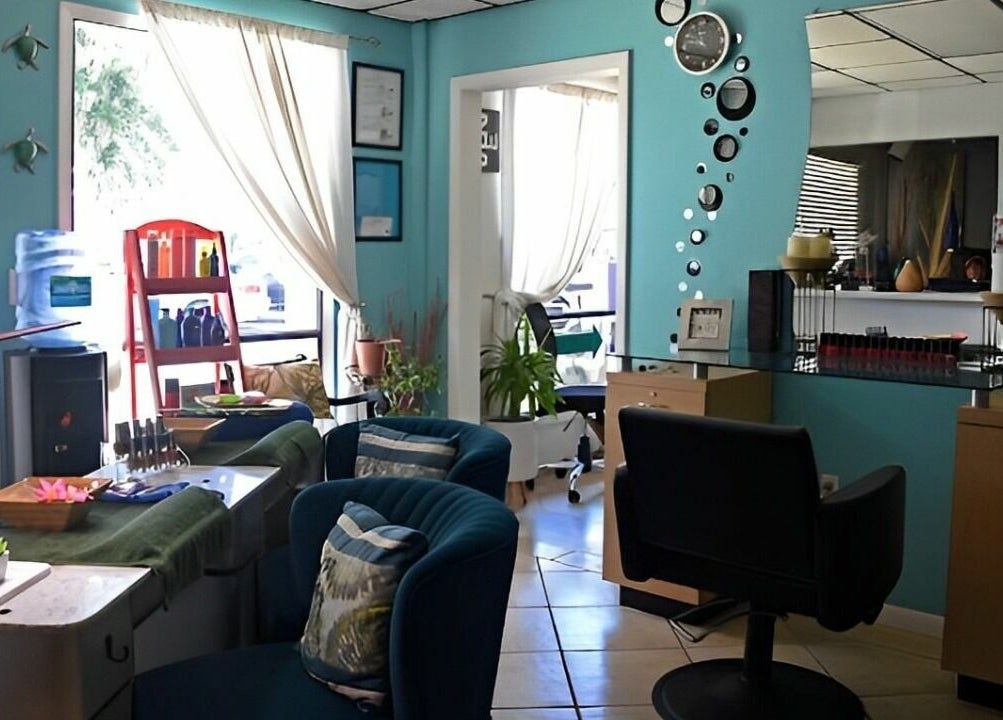 Interior of The Palms Salon and Day Spa, LLC, Edgewater, Florida, US with chic decor and comfortable seating.