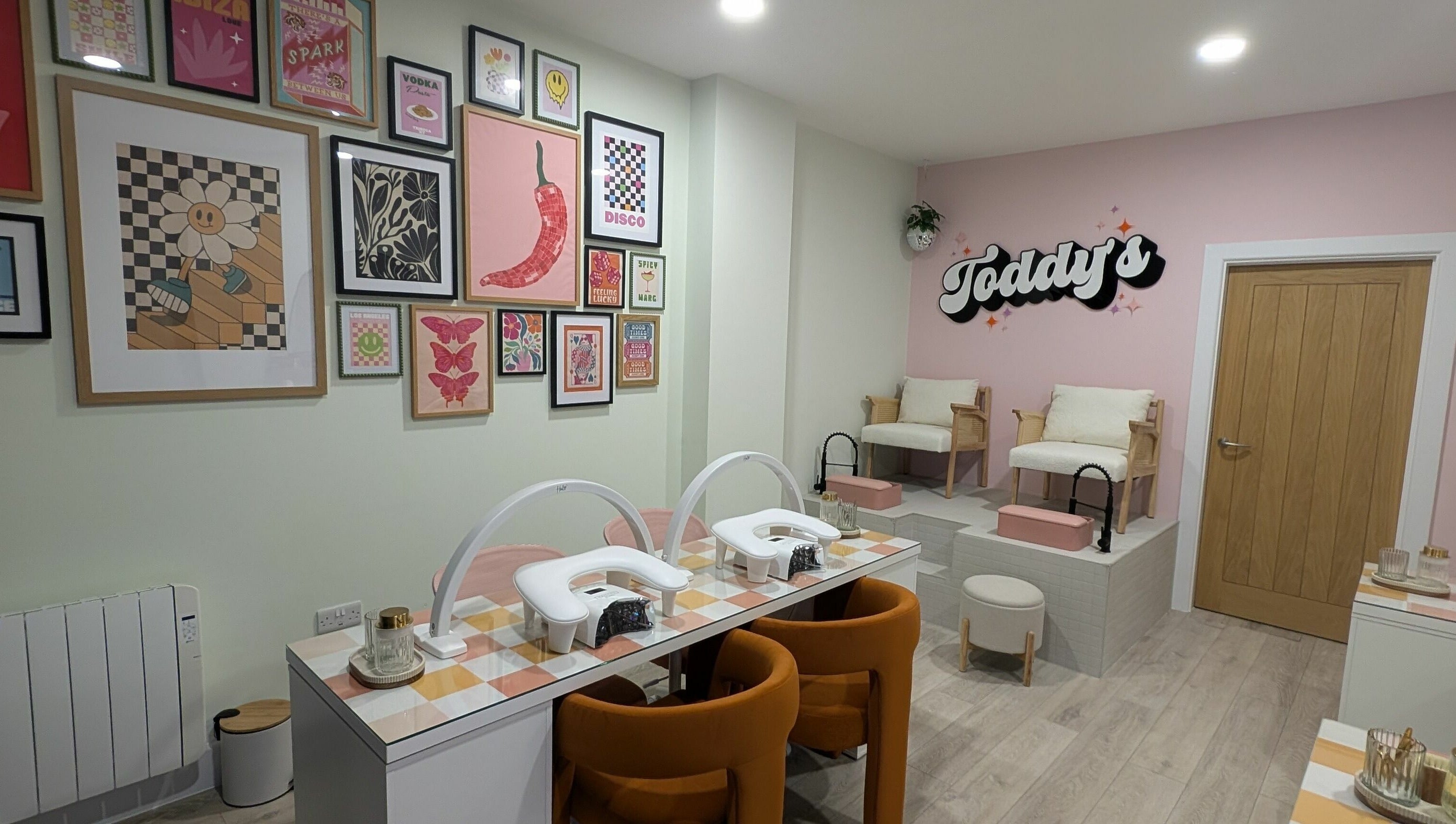 Stylish interior of Toddy's Nails Wadebridge, showcasing vibrant art and manicure stations in Wadebridge, England, GB.