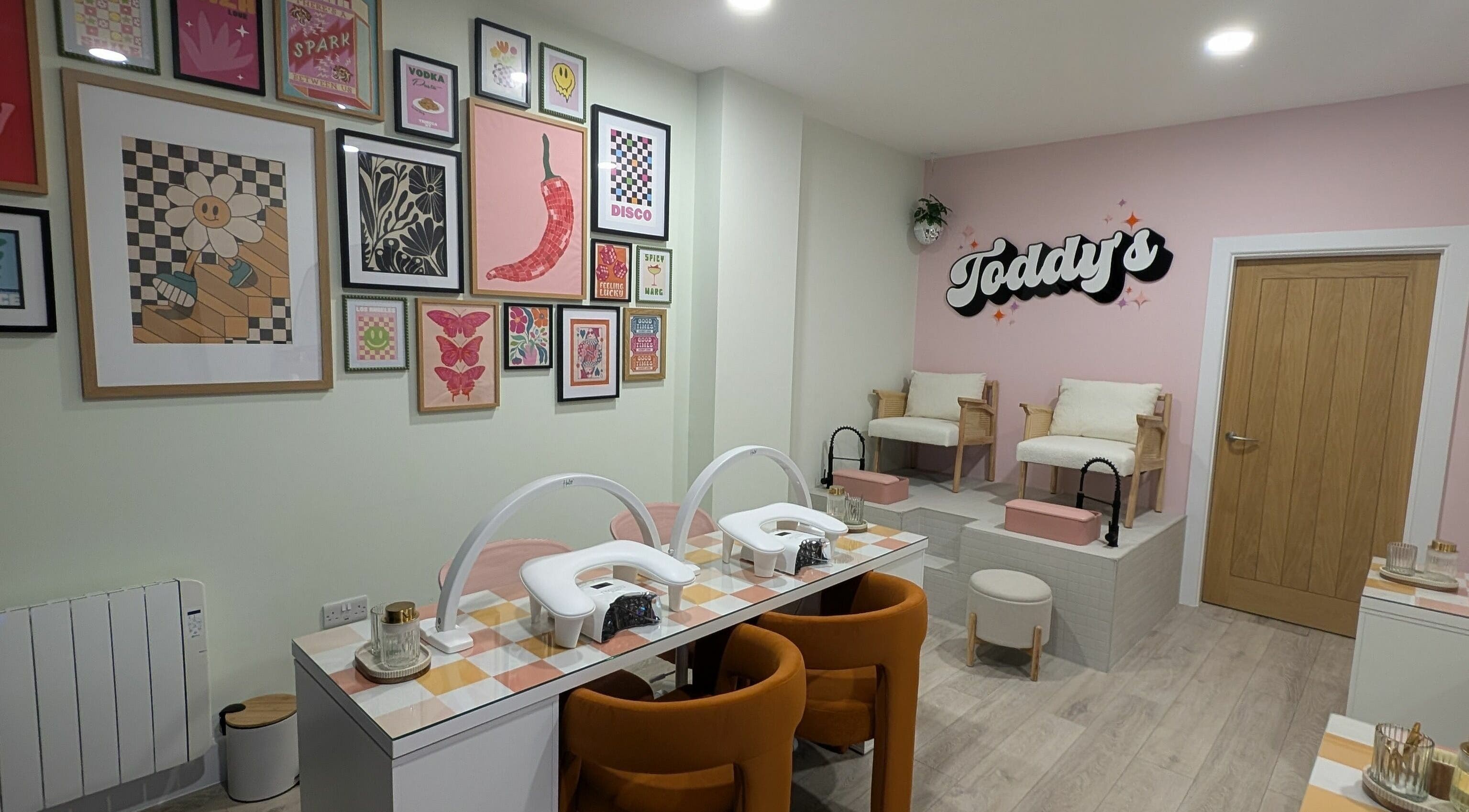 Stylish interior of Toddy's Nails Wadebridge, showcasing vibrant art and manicure stations in Wadebridge, England, GB.