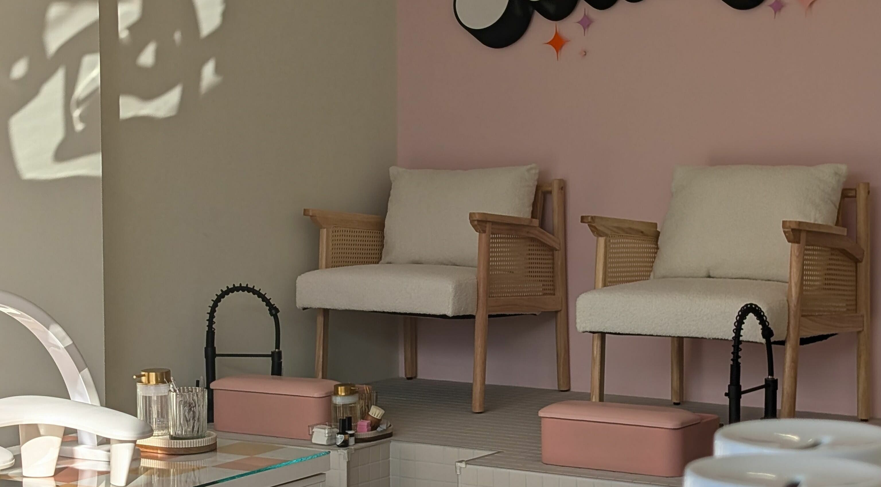 Elegant seating area at Toddy's Nails Wadebridge, featuring cushioned chairs and modern decor in Wadebridge, England, GB.