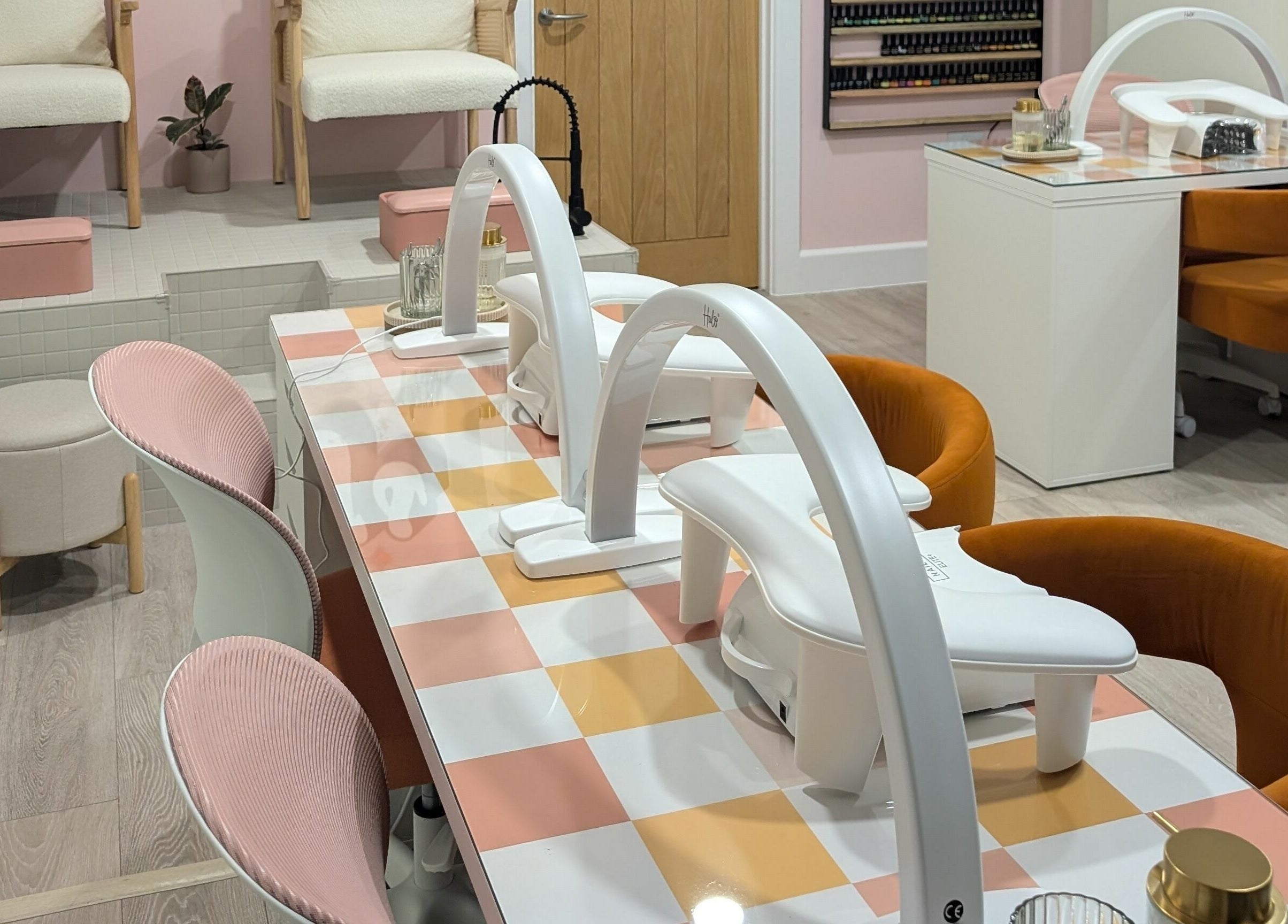 Modern nail salon interior at Toddy's Nails Wadebridge, Wadebridge, England, GB showcasing vibrant seating and workstations.