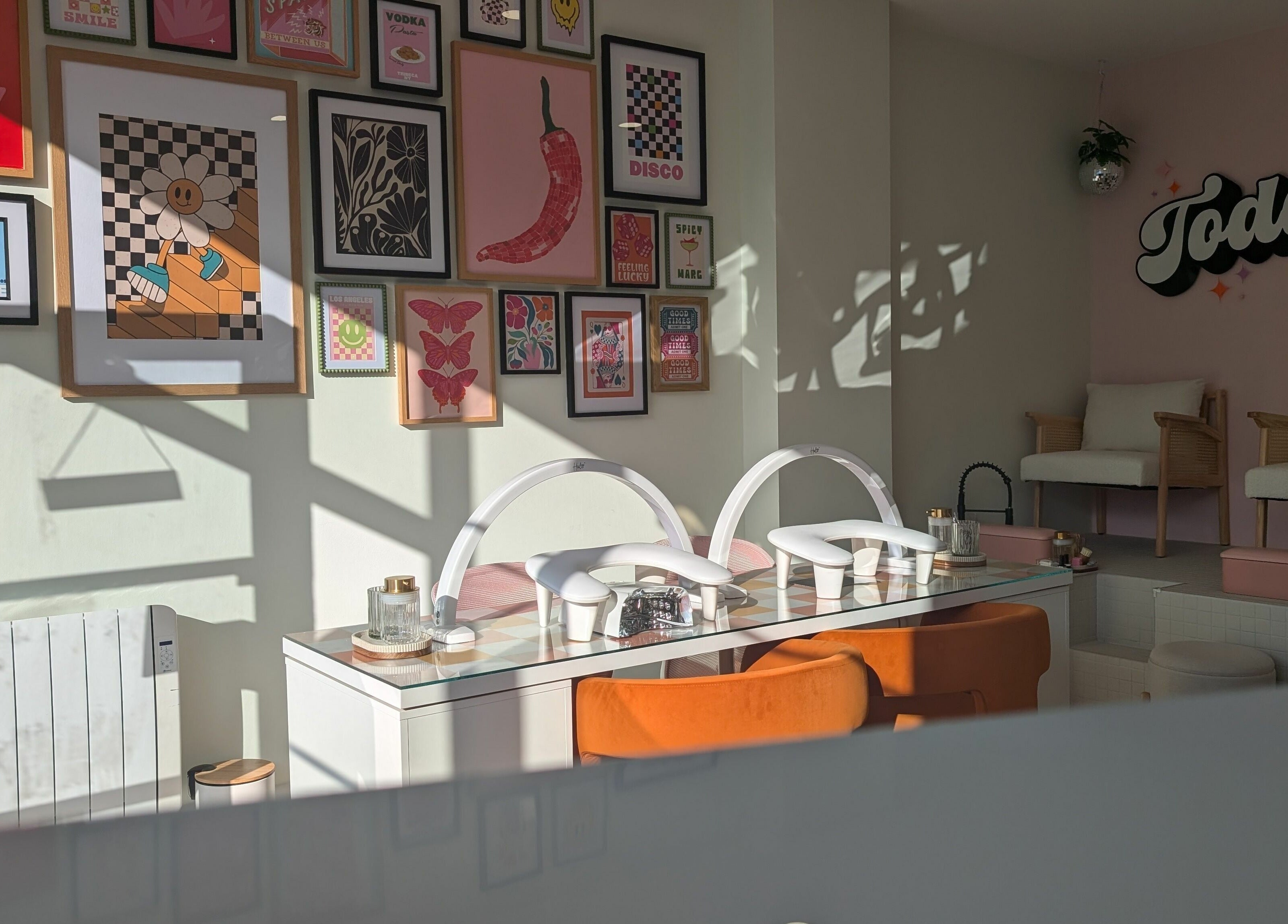 Bright, stylish interior of Toddy's Nails Wadebridge in Wadebridge, England, GB, showcasing artistic decor and seating.