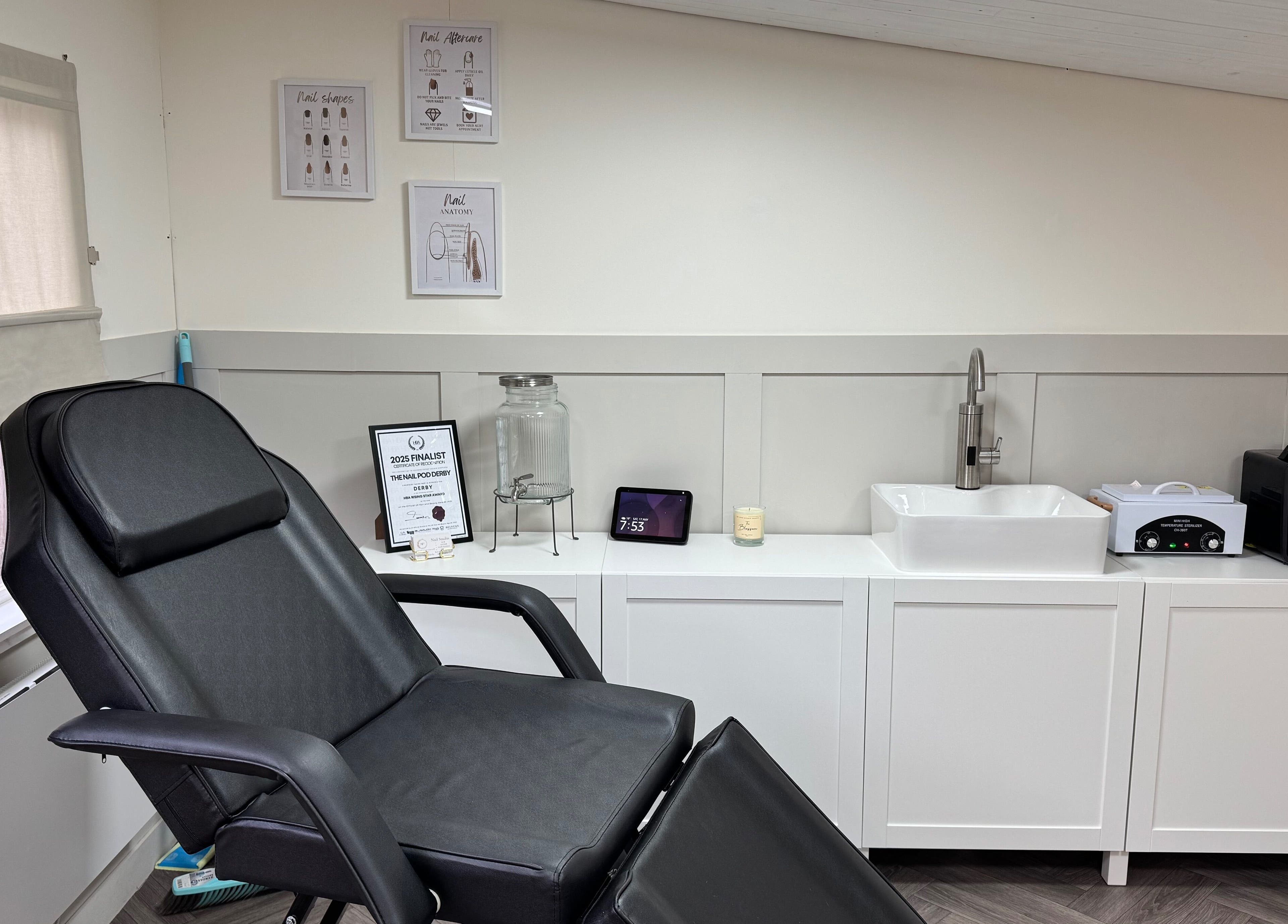 Modern treatment room at Nail Pod Derby in Derby, England, GB featuring a black chair and stylish decor.