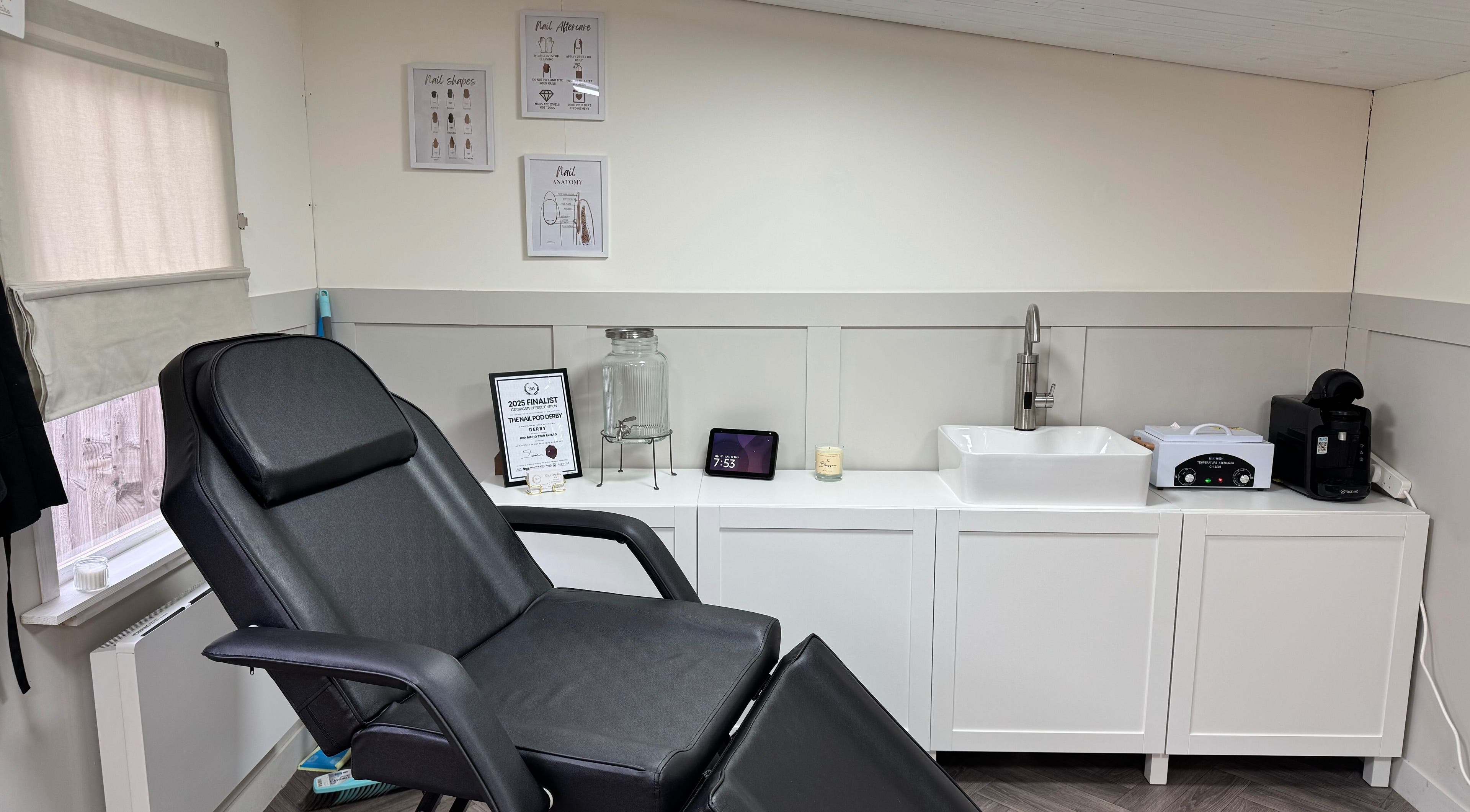 Modern treatment room at Nail Pod Derby in Derby, England, GB featuring a black chair and stylish decor.