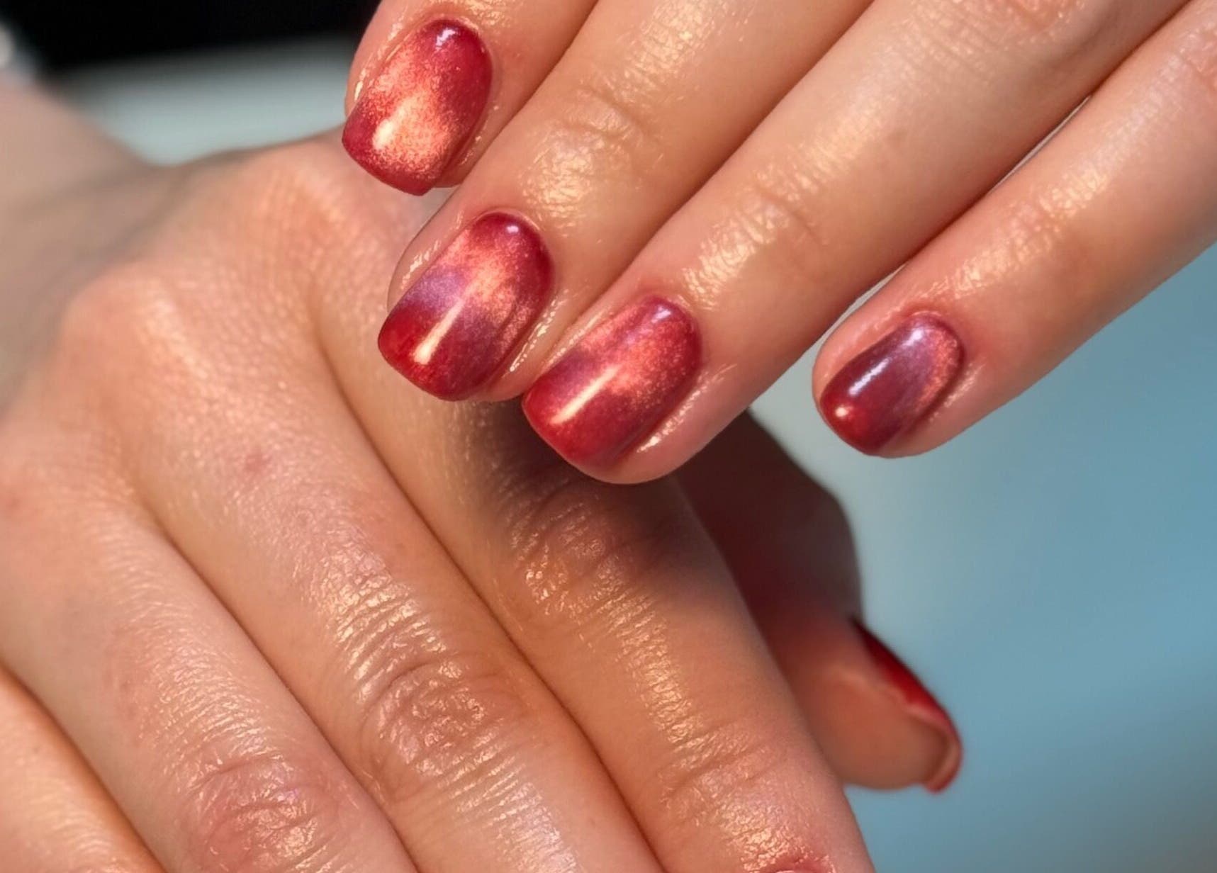 Red polished nails at Nail Pod Derby, showcasing elegant nail art in Derby, England, GB.