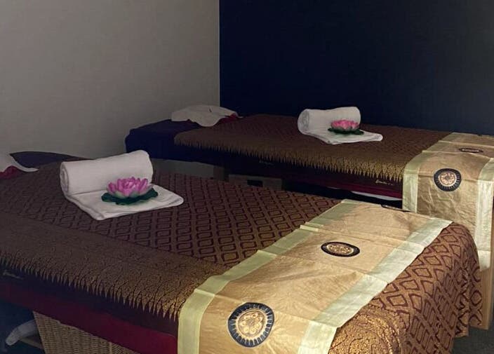 Calming massage room at Belmont Thai Massage Station, Auckland, NZ, featuring inviting decor and twin tables.