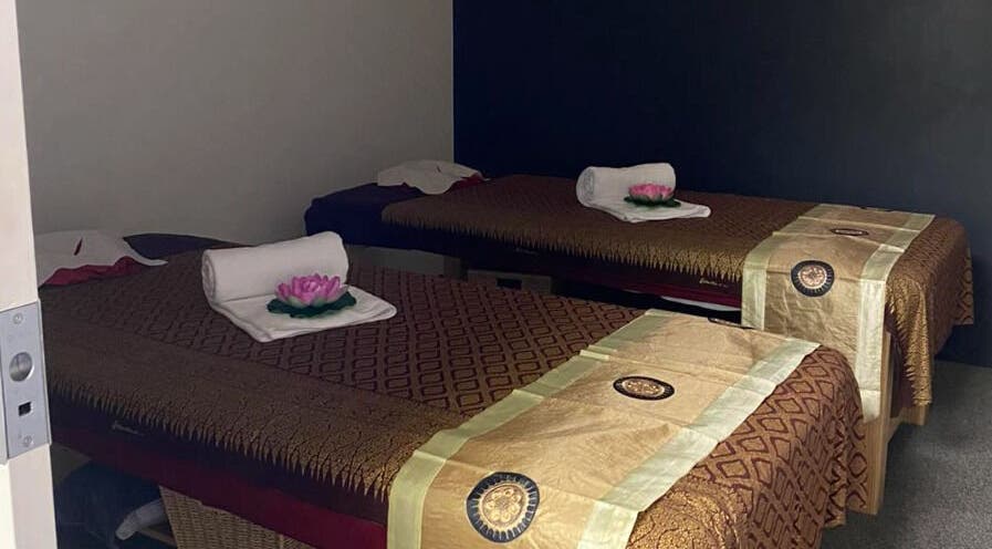 Calming massage room at Belmont Thai Massage Station, Auckland, NZ, featuring inviting decor and twin tables.