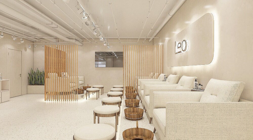 Elegant interior of Leo Nail Lounge in Caledonia, Ontario, CA, featuring plush seating and modern design.