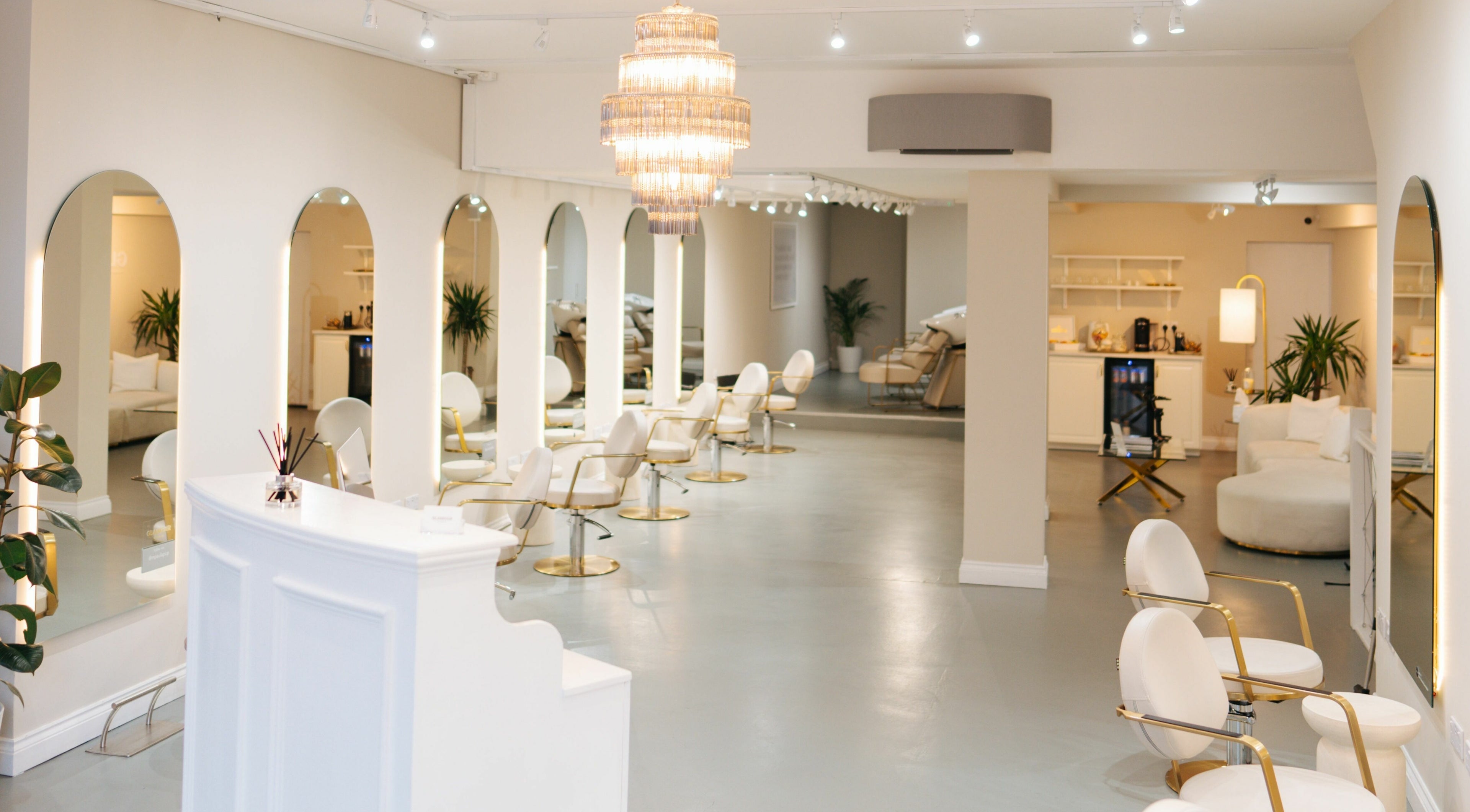 Elegant interior of Glamhair Studio, London, England, GB showcasing plush seating and modern decor.