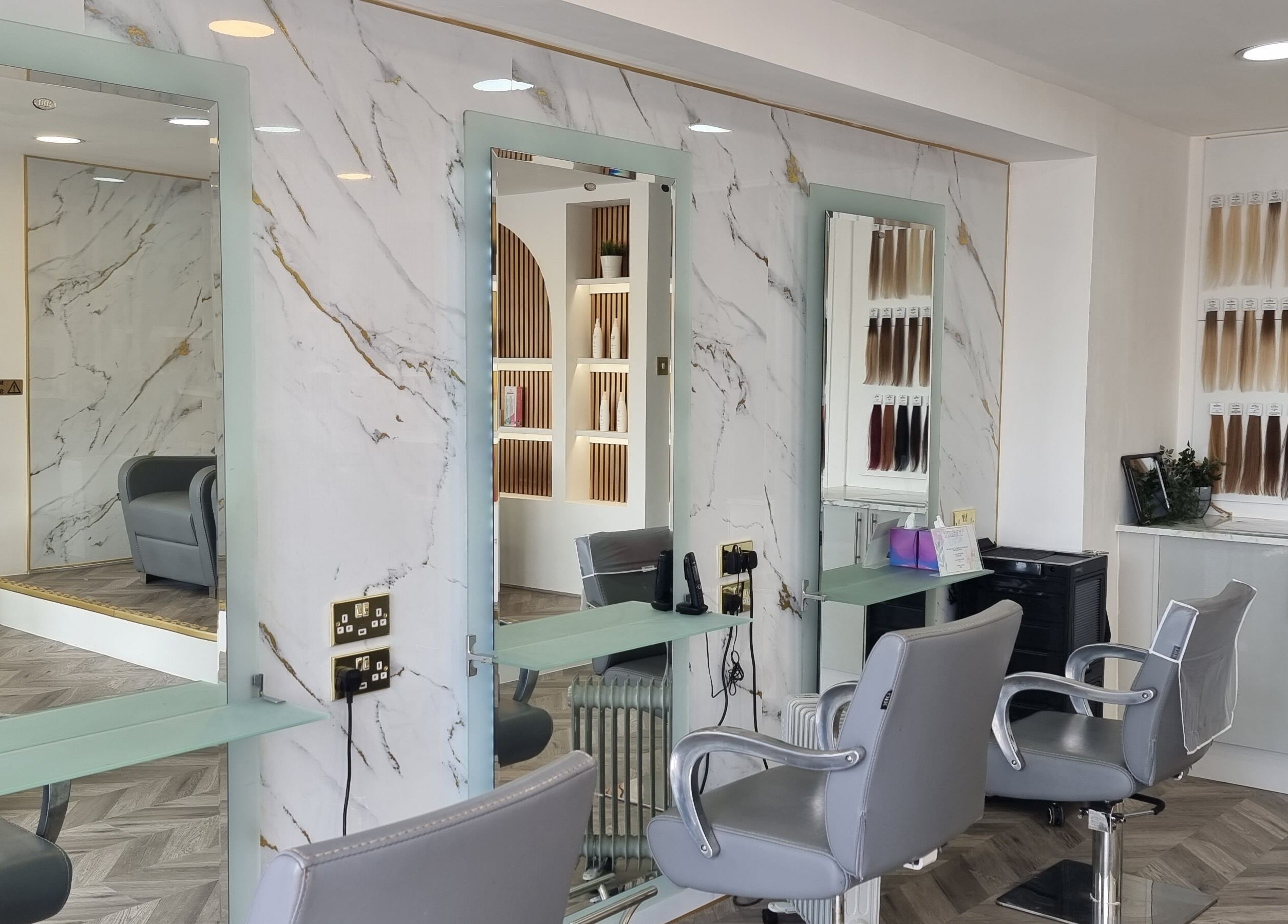 Elegant salon at HairArt_bydennileigh in Eccles, England, GB with mirrors and hair extension display.