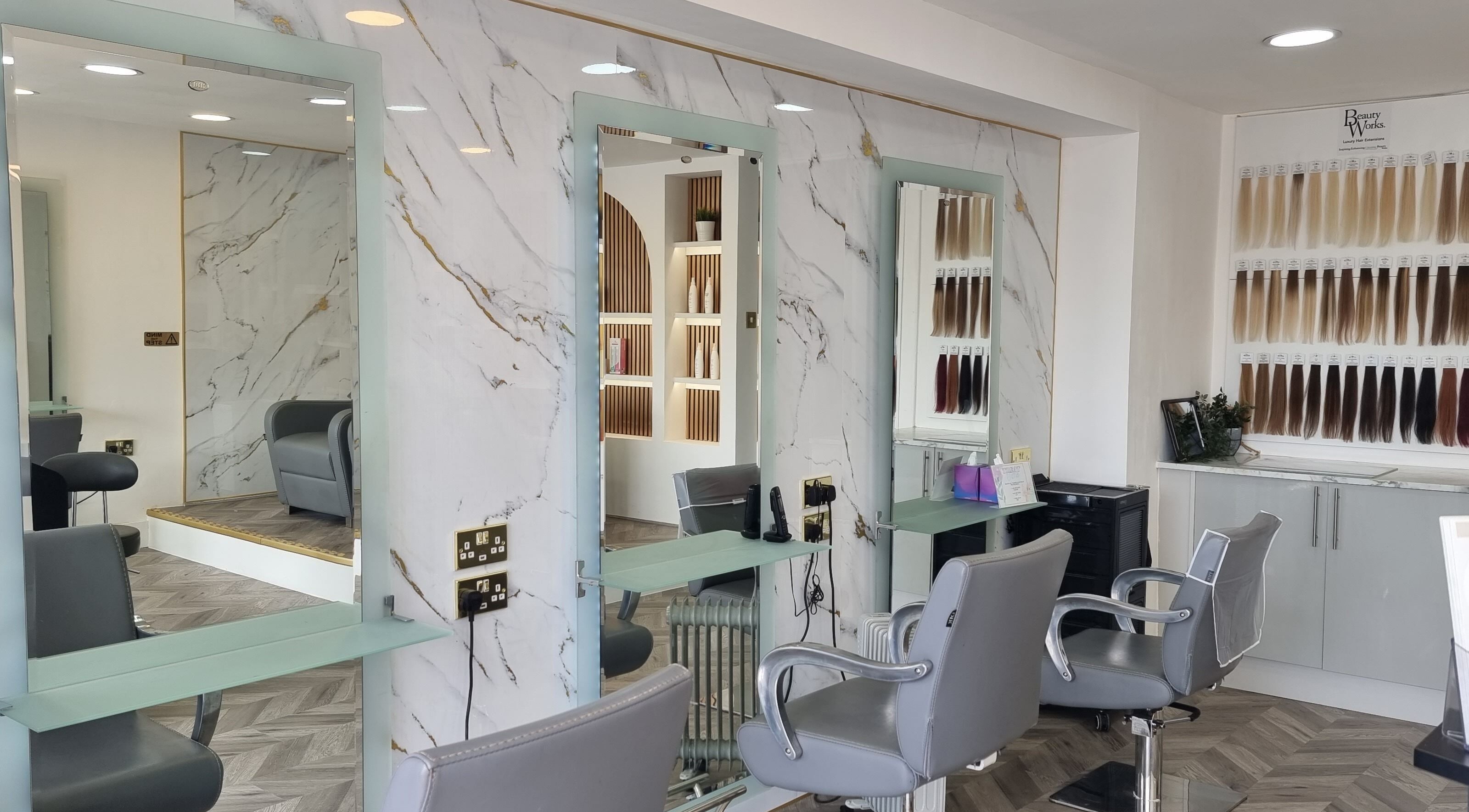 Elegant salon at HairArt_bydennileigh in Eccles, England, GB with mirrors and hair extension display.