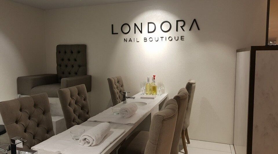 Elegant interior of Londora Nail Boutique, Newbury, England, GB with plush chairs and a modern workspace.