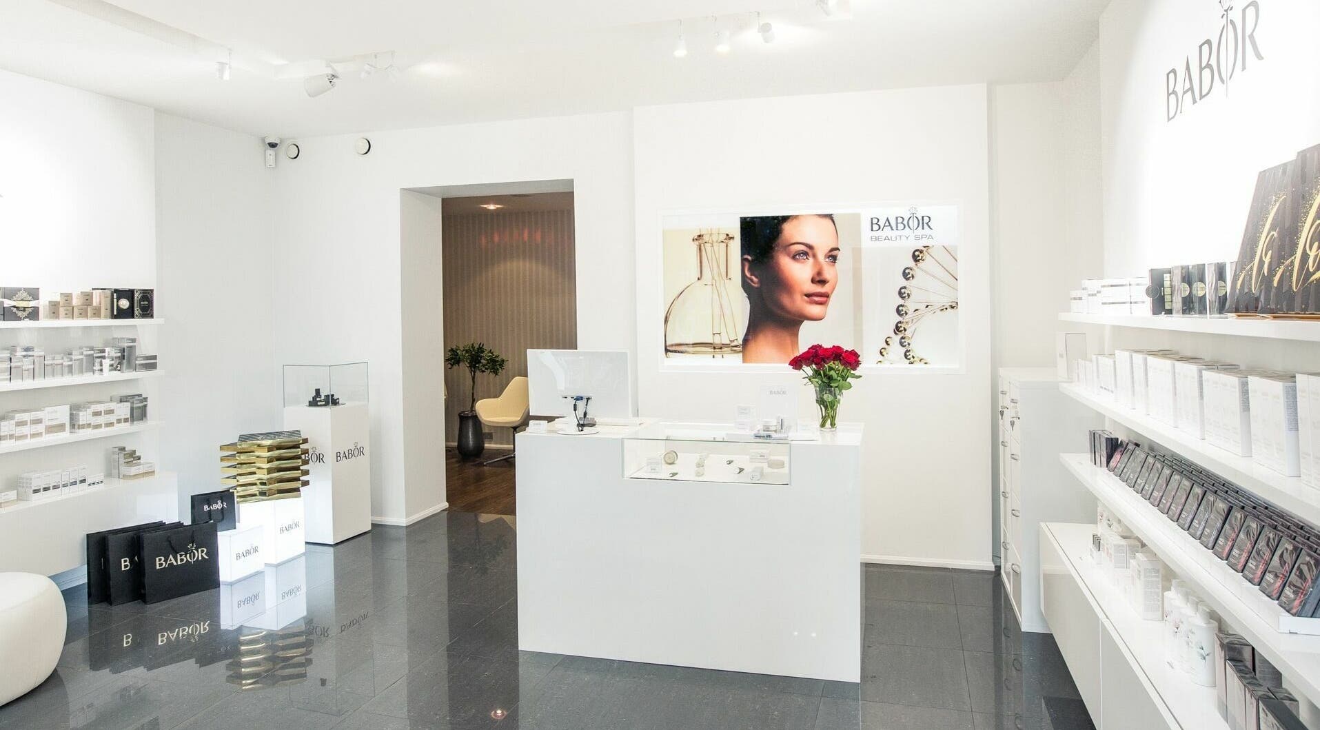 Elegant reception area of Babor Beauty Spa, Rīga, LV with luxurious products displayed and soft lighting.