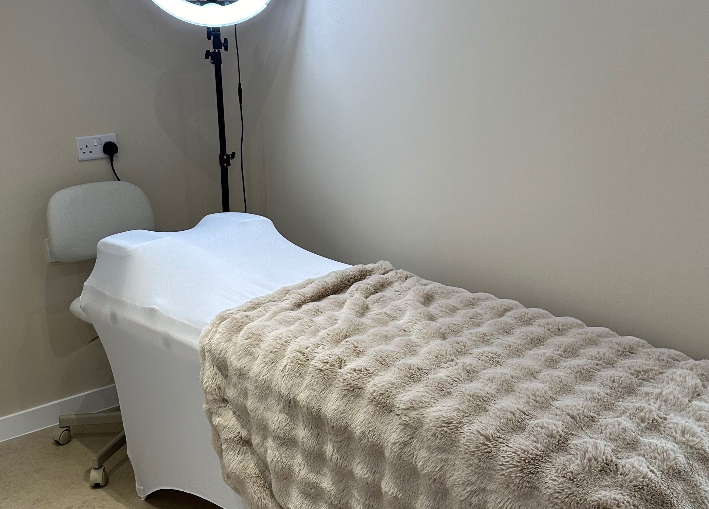 Relaxing massage table at Created in Swinton, England, GB, featuring soft lighting and plush linens.
