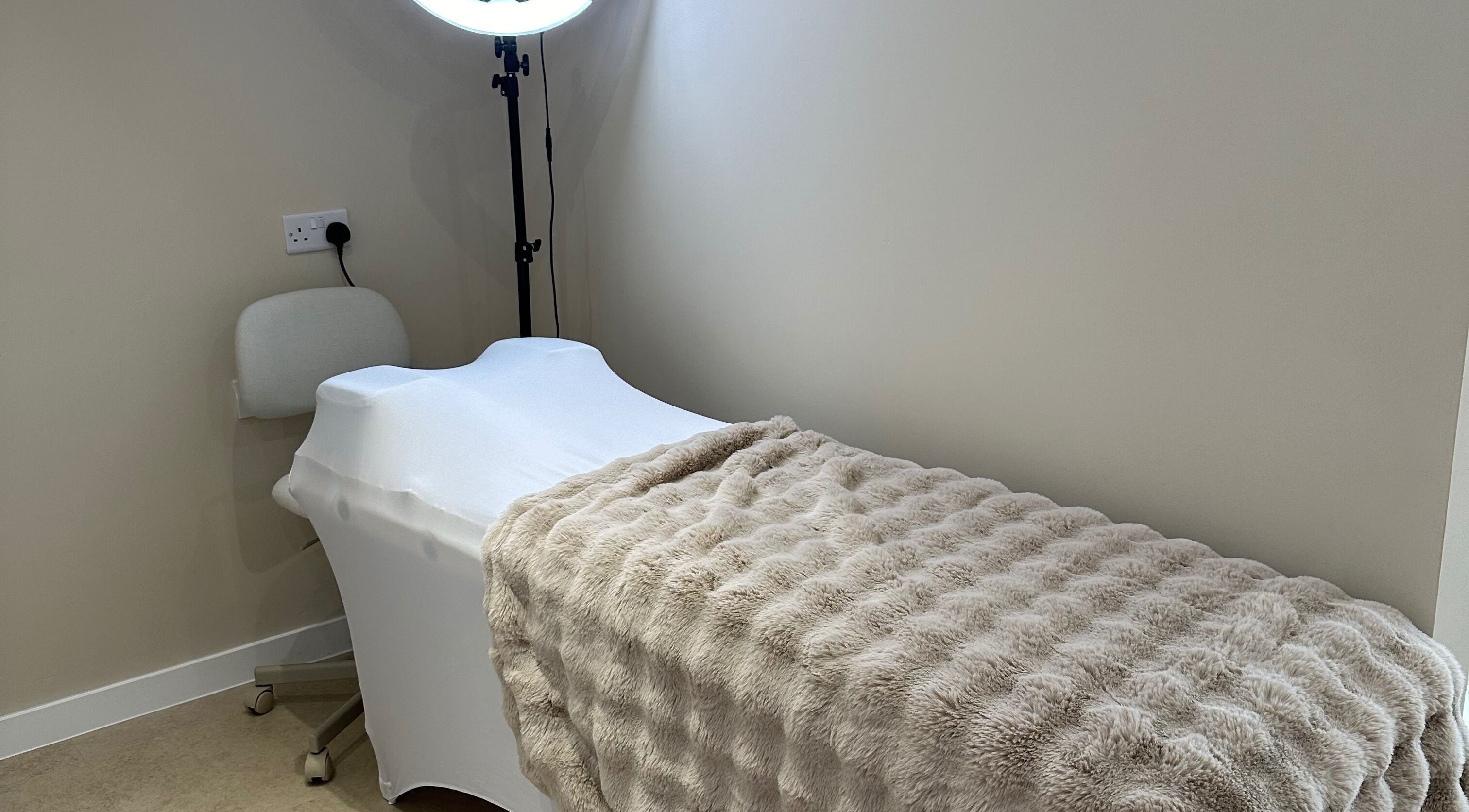 Relaxing massage table at Created in Swinton, England, GB, featuring soft lighting and plush linens.
