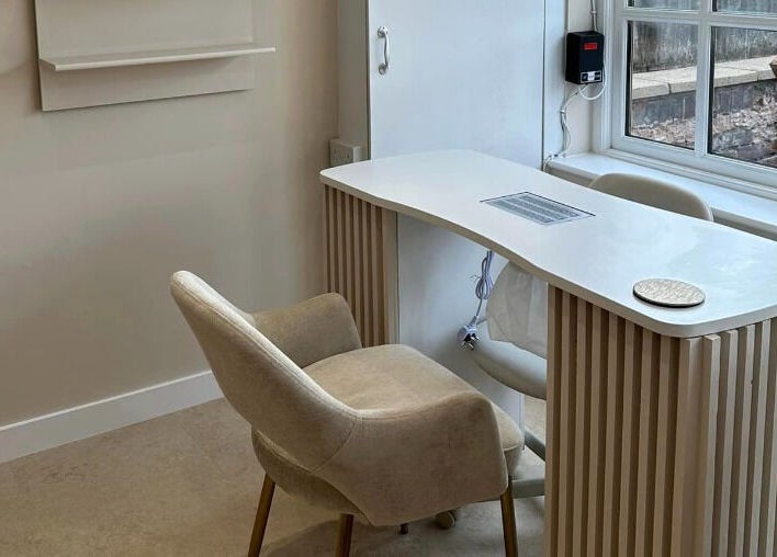 Sleek nail station at Created, Swinton, England, GB, featuring a comfortable beige chair and modern white desk.