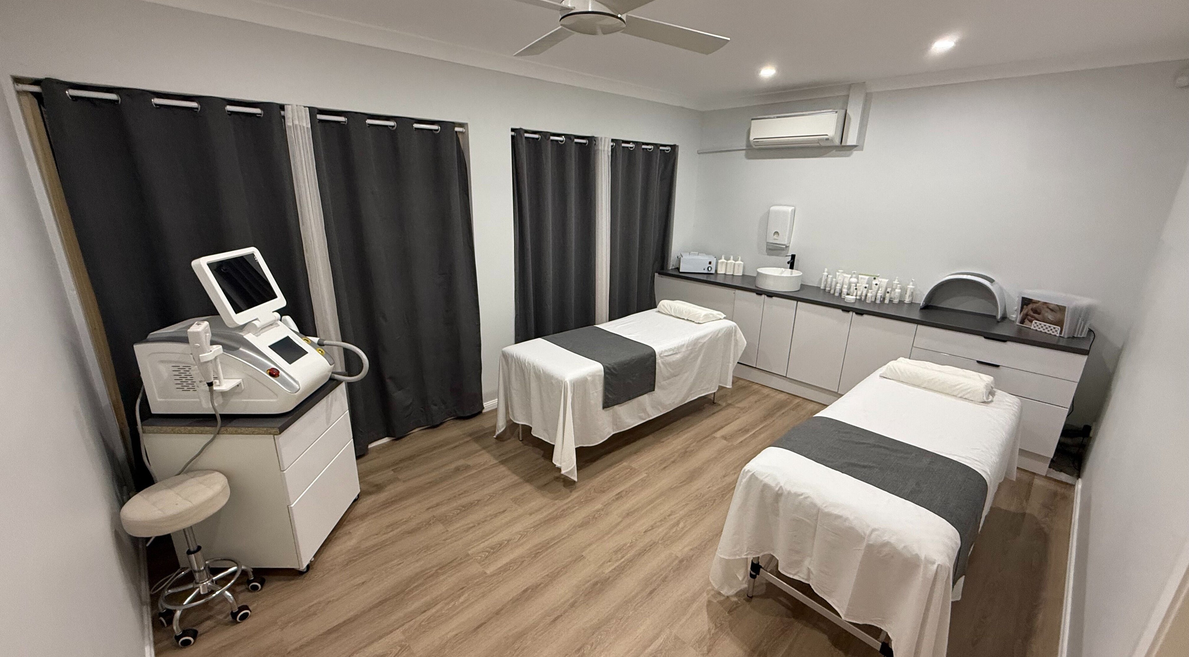 Modern treatment room at Alira Wellness Collective, Morisset, New South Wales, AU with two spa beds and equipment.