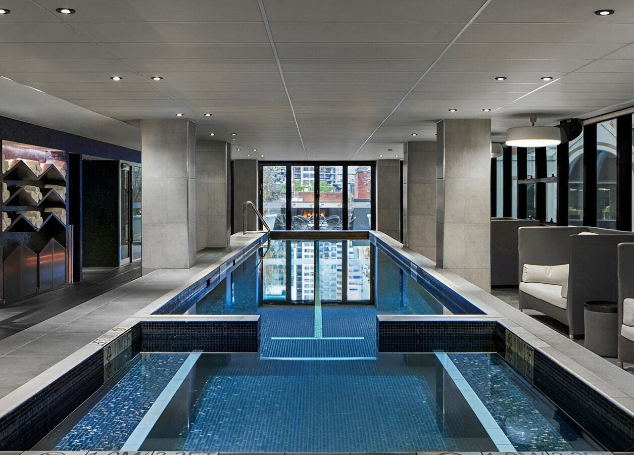 Luxurious indoor pool at IOMI Spa at Sheraton Hotel in Melbourne, Victoria, AU, perfect for relaxation.