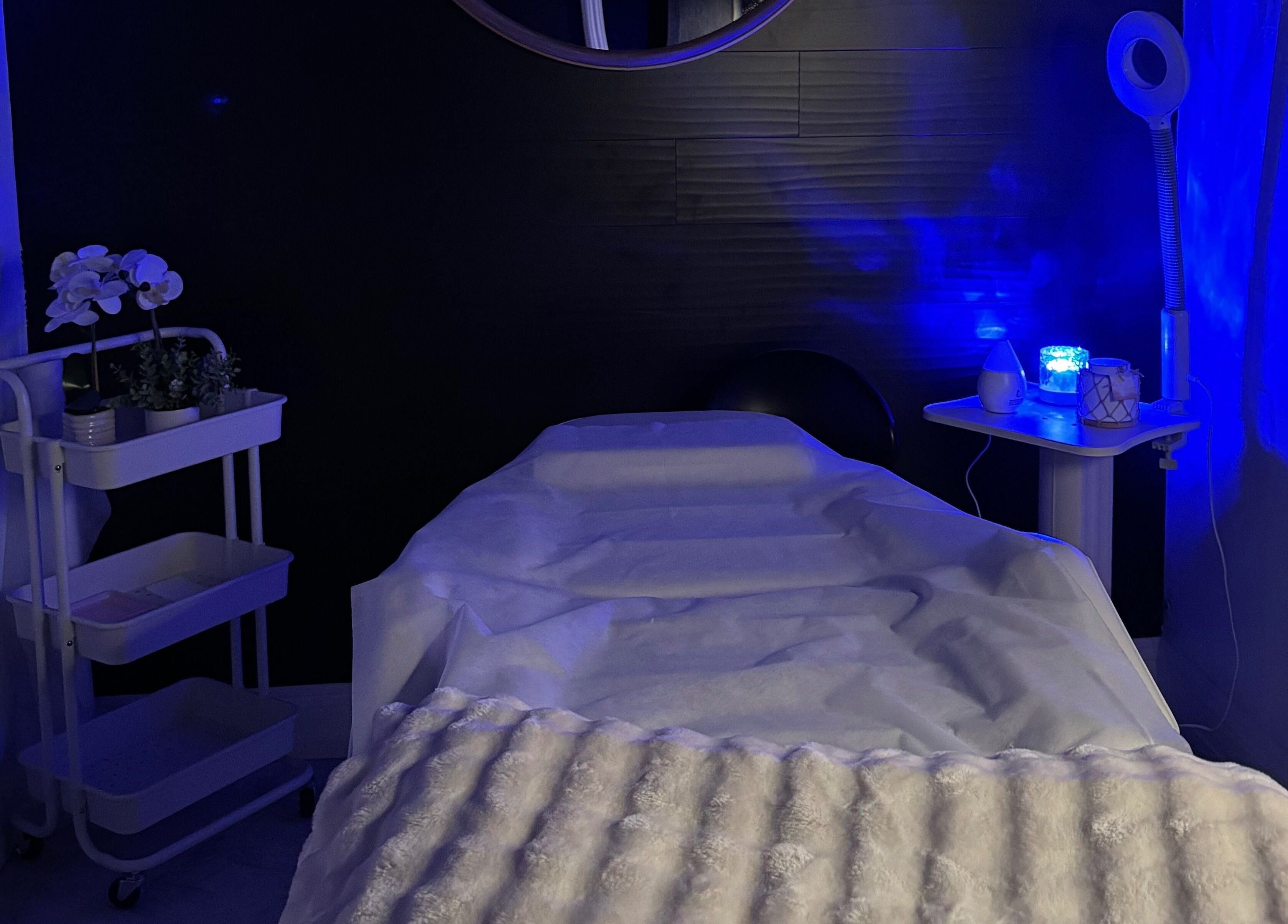 Tranquil treatment room at Leghecy Beauty Salon in Costa Mesa, California, US, with calming blue lighting.