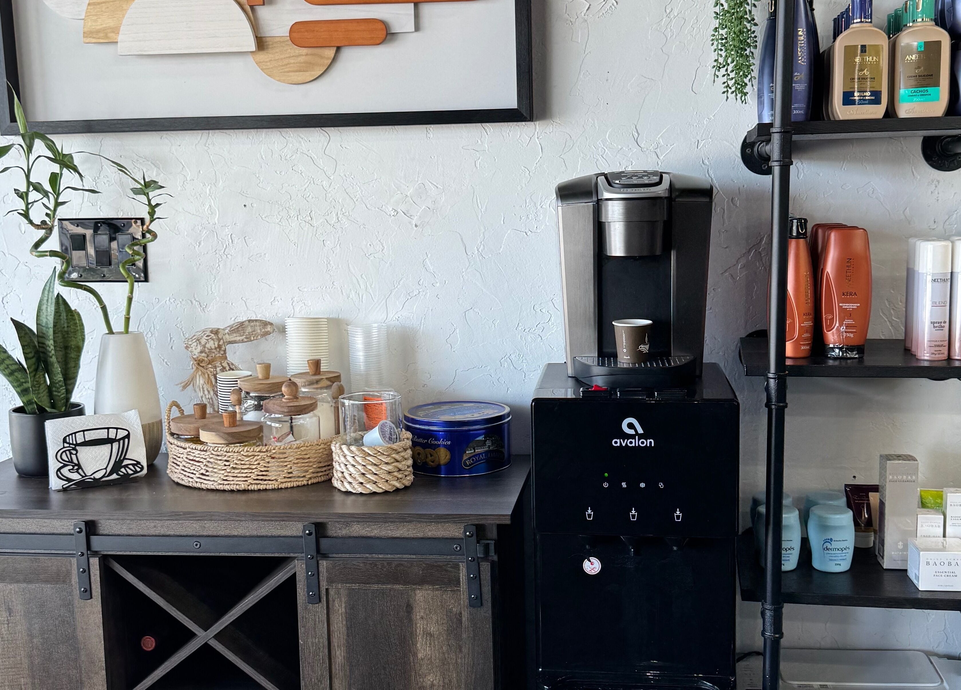 Relaxing refreshment corner at Leghecy Beauty Salon in Costa Mesa, California, US with coffee and decor.