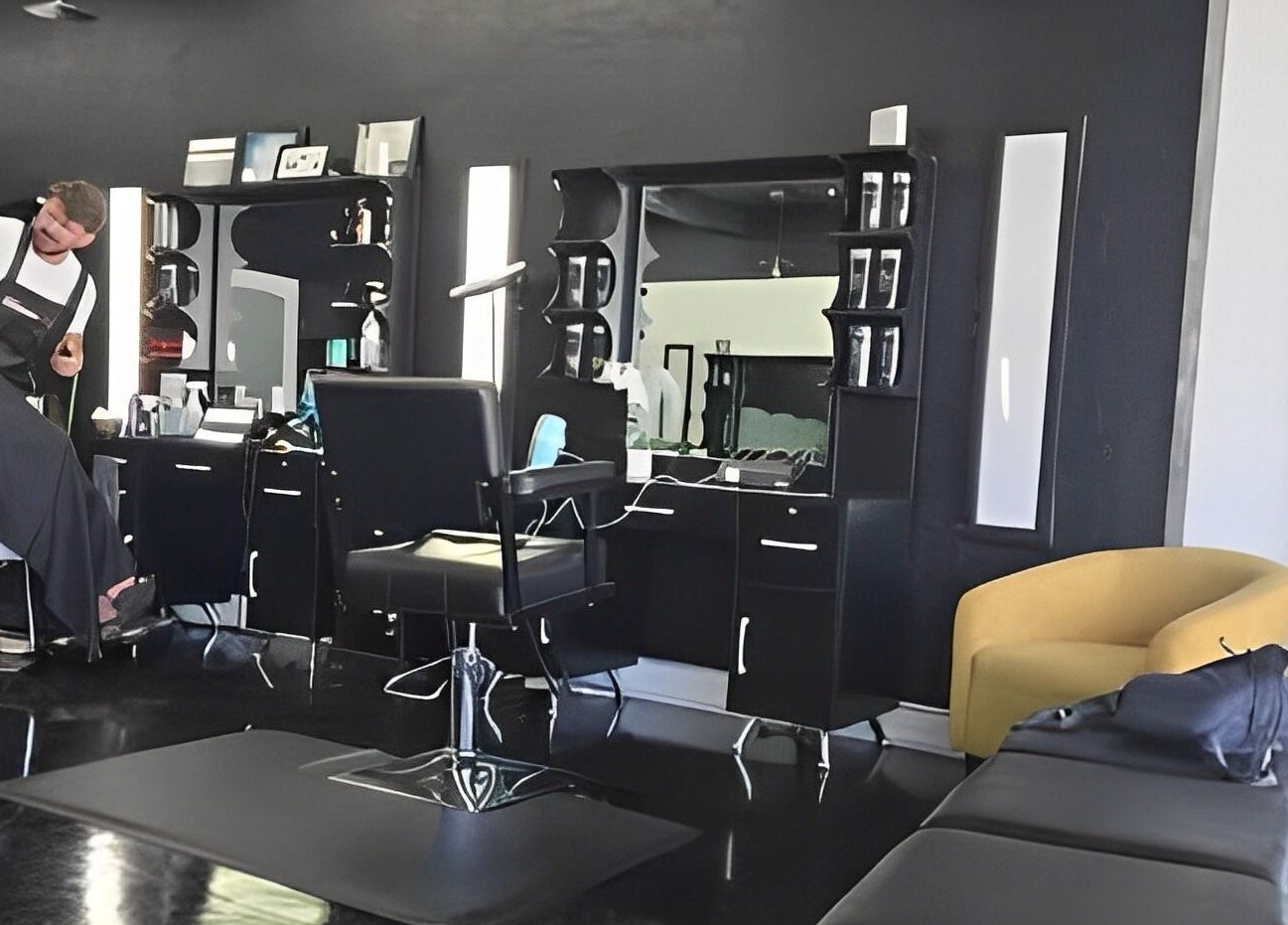 Interior of Leghecy Beauty Salon in Costa Mesa, California, showcasing a stylist at work in a modern setting.