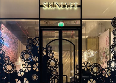 Front entrance of Skinlyft, an elegant beauty space in Dubai with decorative patterns and warm lighting.
