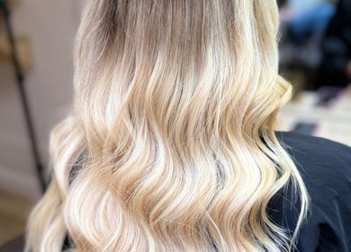 Blonde hair extensions styled in soft waves at Georgia J Extensions, Bicester, England, GB.
