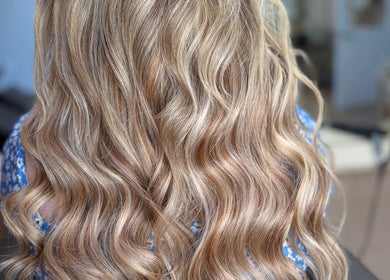 Voluminous blonde waves styled at Georgia J Extensions, Bicester, England, GB, showcasing premium hair care.