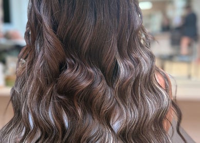 Elegant wavy brunette hair styled at Georgia J Extensions, Bicester, England, GB.