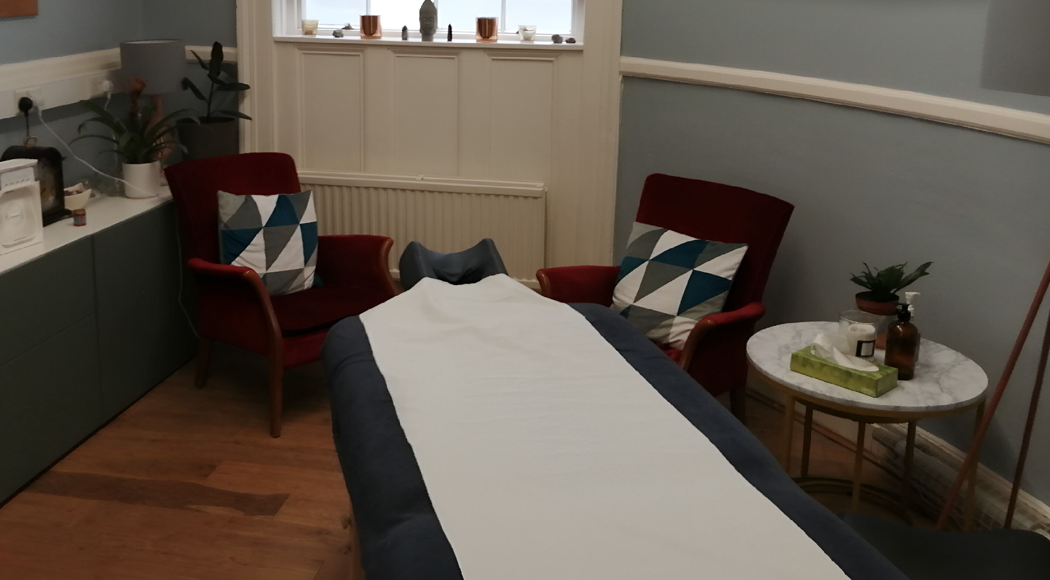 Relaxing interior of Rico Sports Massage Therapy, Liverpool, England, GB with massage table and chairs.