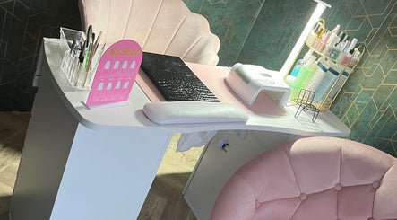 Chic manicure station at Vip Nails By Wafa in Glasgow, Scotland, GB, featuring plush pink chairs and nail tools.