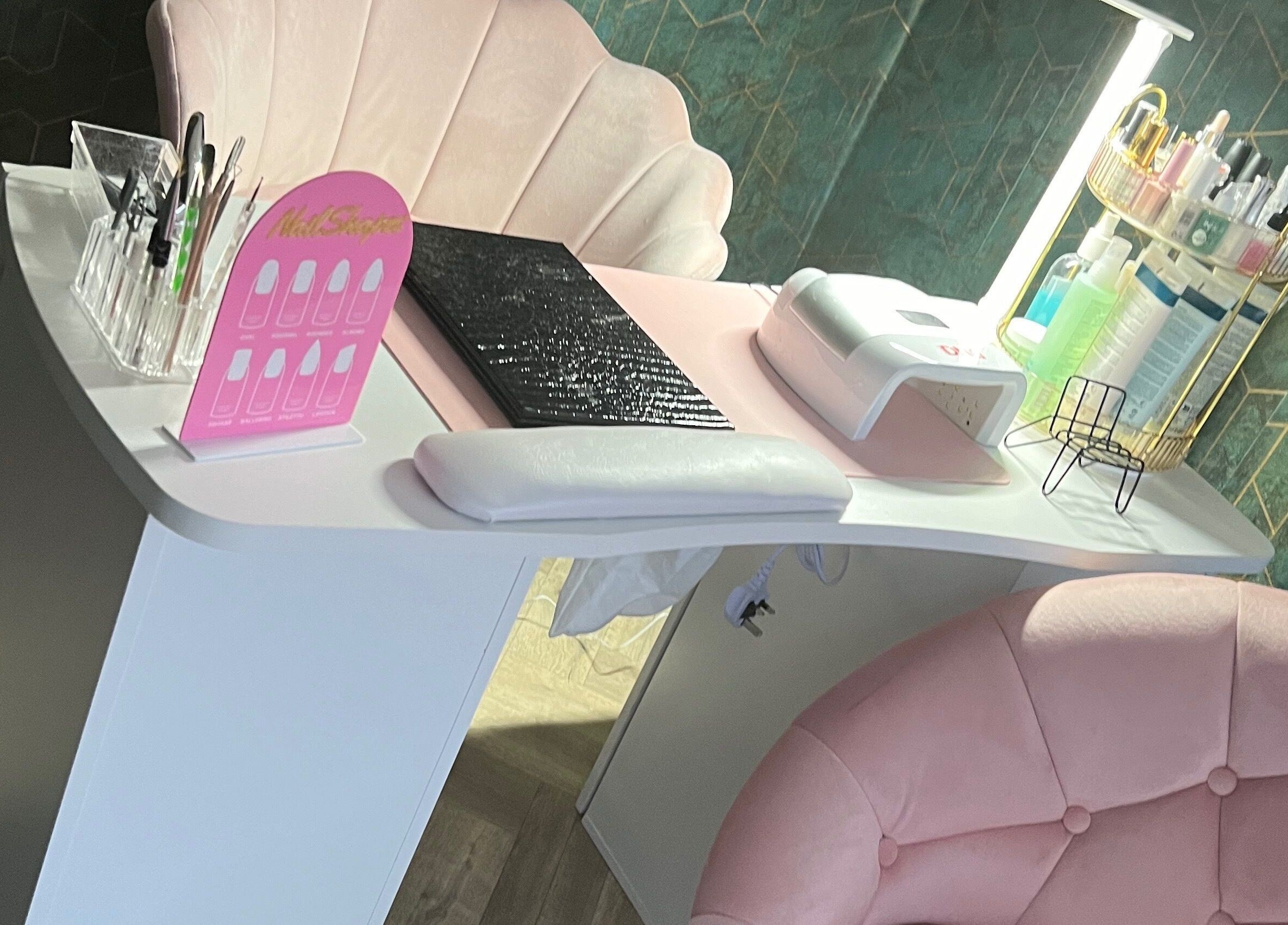 Elegant nail station setup at Vip Nails By Wafa, Glasgow, Scotland, GB with pink seating and manicure tools.