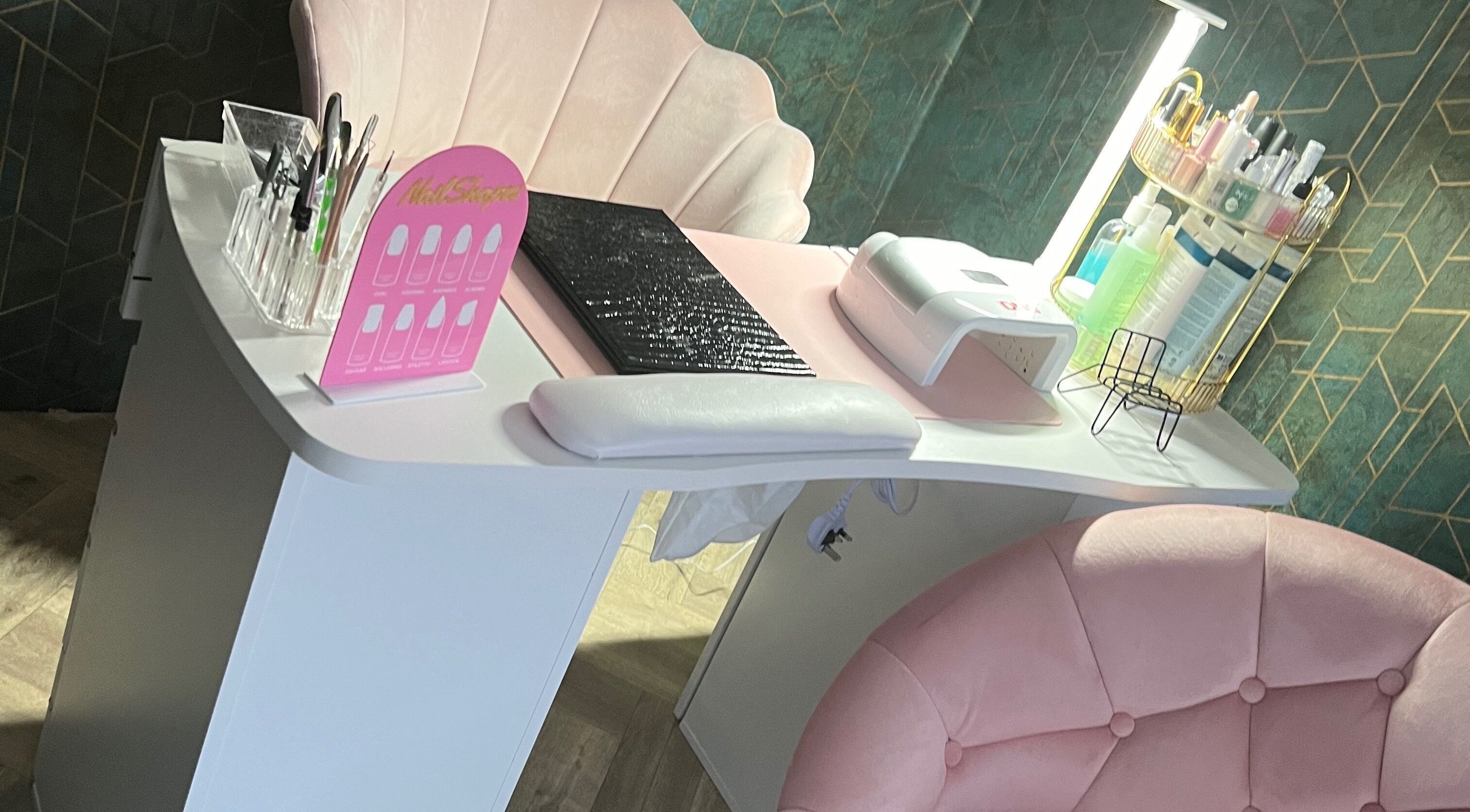 Elegant nail station setup at Vip Nails By Wafa, Glasgow, Scotland, GB with pink seating and manicure tools.