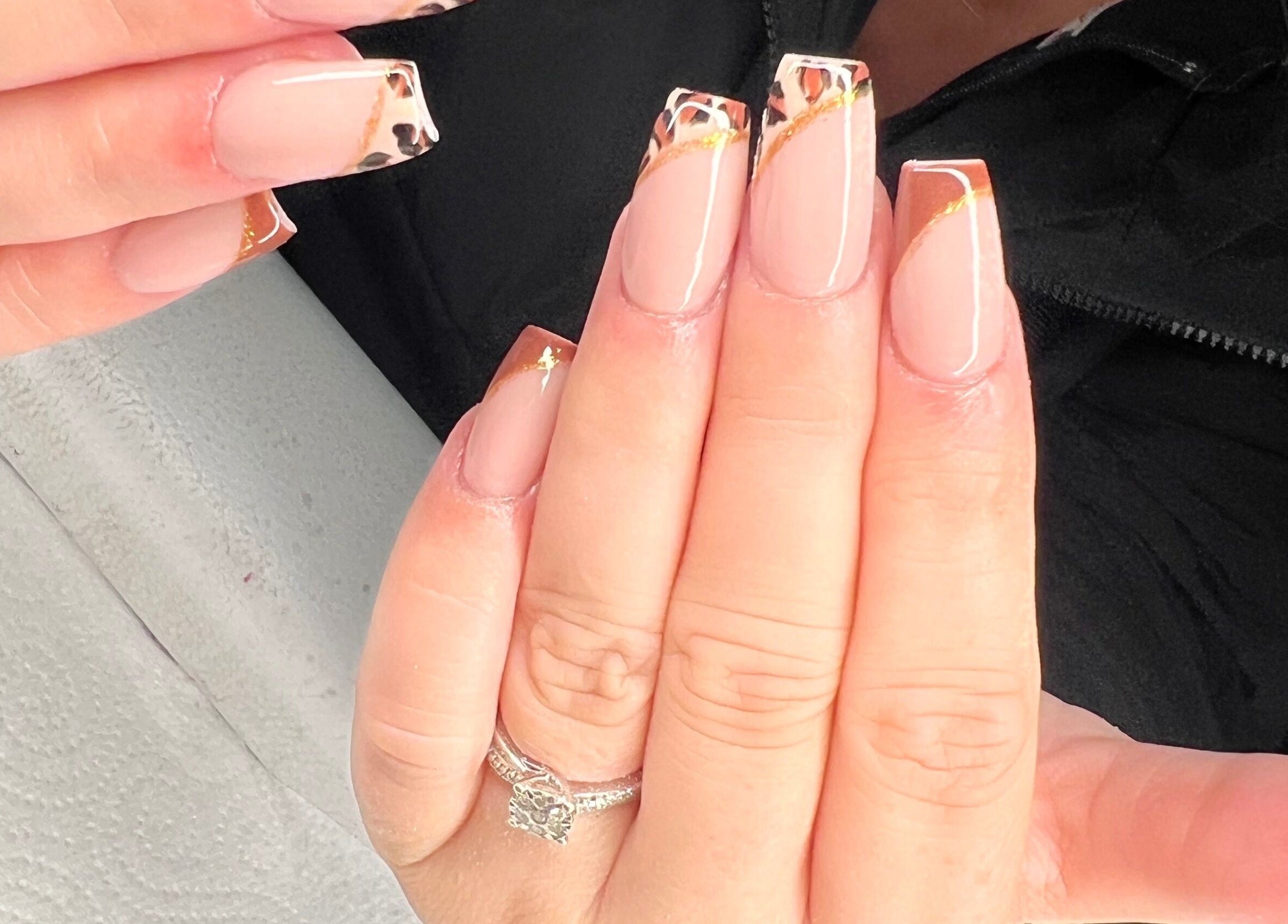 Elegant nail art at Vip Nails By Wafa, showcasing long nude nails with decorative tips in Glasgow, Scotland, GB.