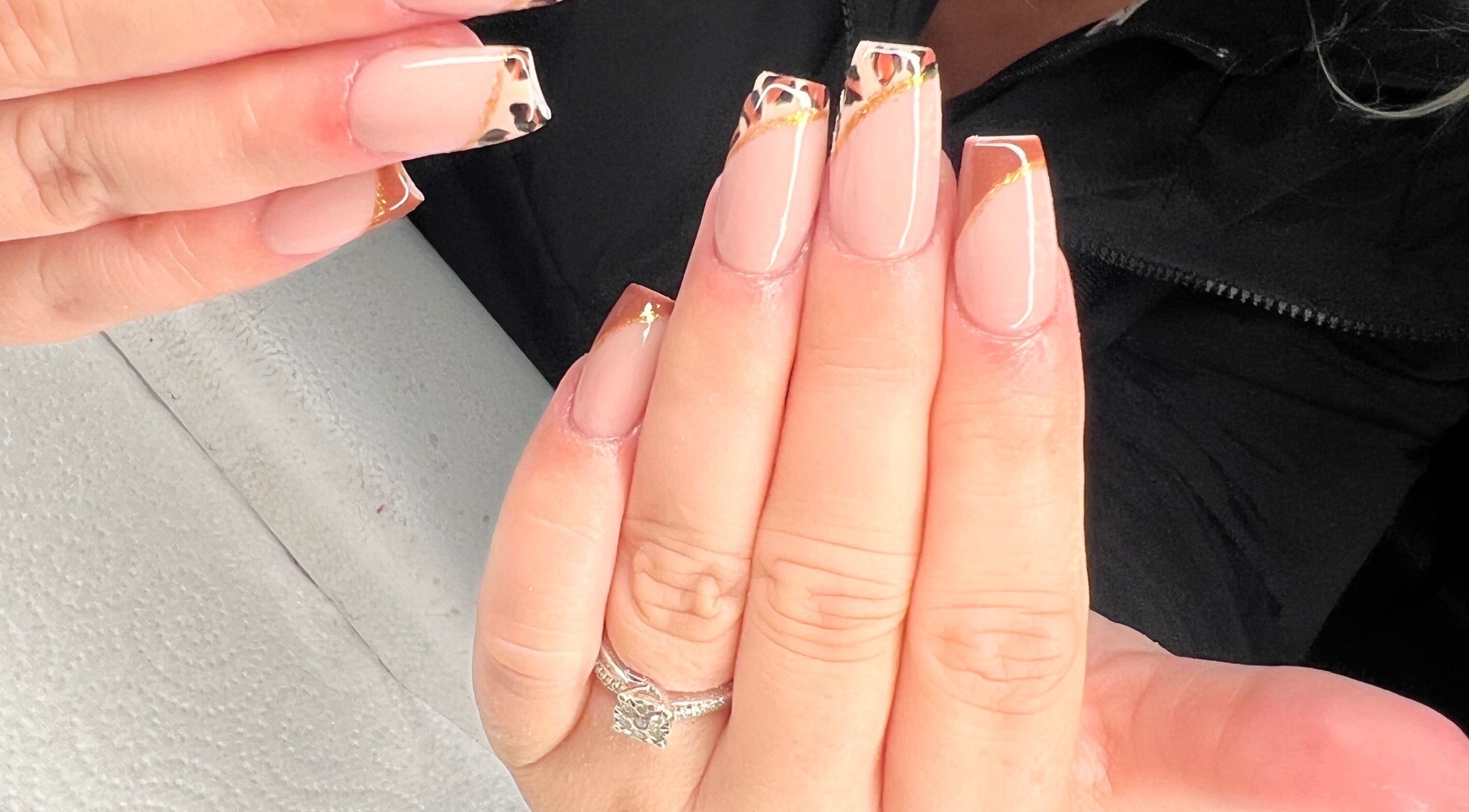 Elegant nail art at Vip Nails By Wafa, showcasing long nude nails with decorative tips in Glasgow, Scotland, GB.