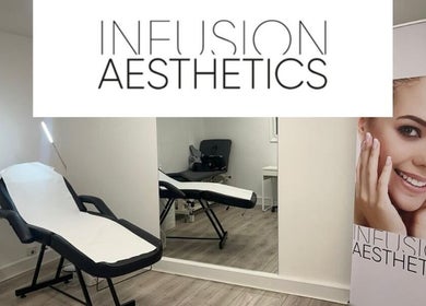 Modern treatment room at Infusion Aesthetics UT Clinic, Burgess Hill, GB, featuring a sleek massage bed and mirror.