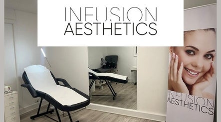 Modern treatment room at Infusion Aesthetics UT Clinic, Burgess Hill, GB, featuring a sleek massage bed and mirror.