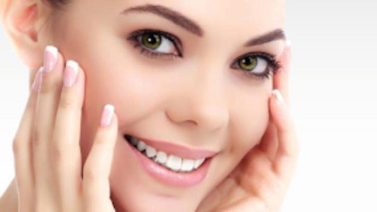 Smiling woman showcasing radiant skin at Infusion Aesthetics, Burgess Hill, England, GB.