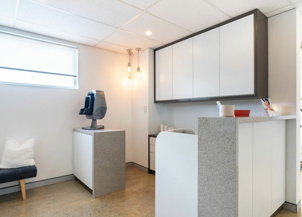 Modern reception area at Sophie Austin Skin, Karrinyup, WA, AU, showcasing sleek design and warm lighting.