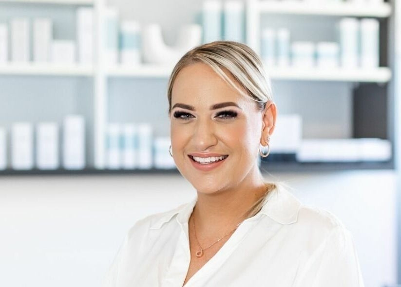 A friendly staff member at Sophie Austin Skin, Karrinyup, WA, AU, welcoming clients with a bright smile.