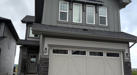 Modern gray exterior of Le Body Space in Cochrane, Alberta, CA showcasing elegant architectural design.