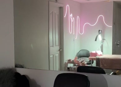 Chic treatment room with neon decor at Be You tybykim, Edmonton, Alberta, CA.