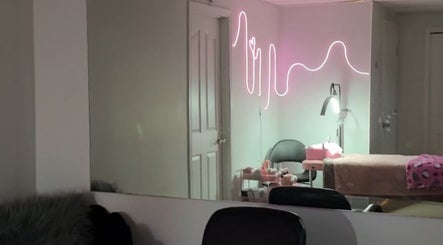 Chic treatment room with neon decor at Be You tybykim, Edmonton, Alberta, CA.