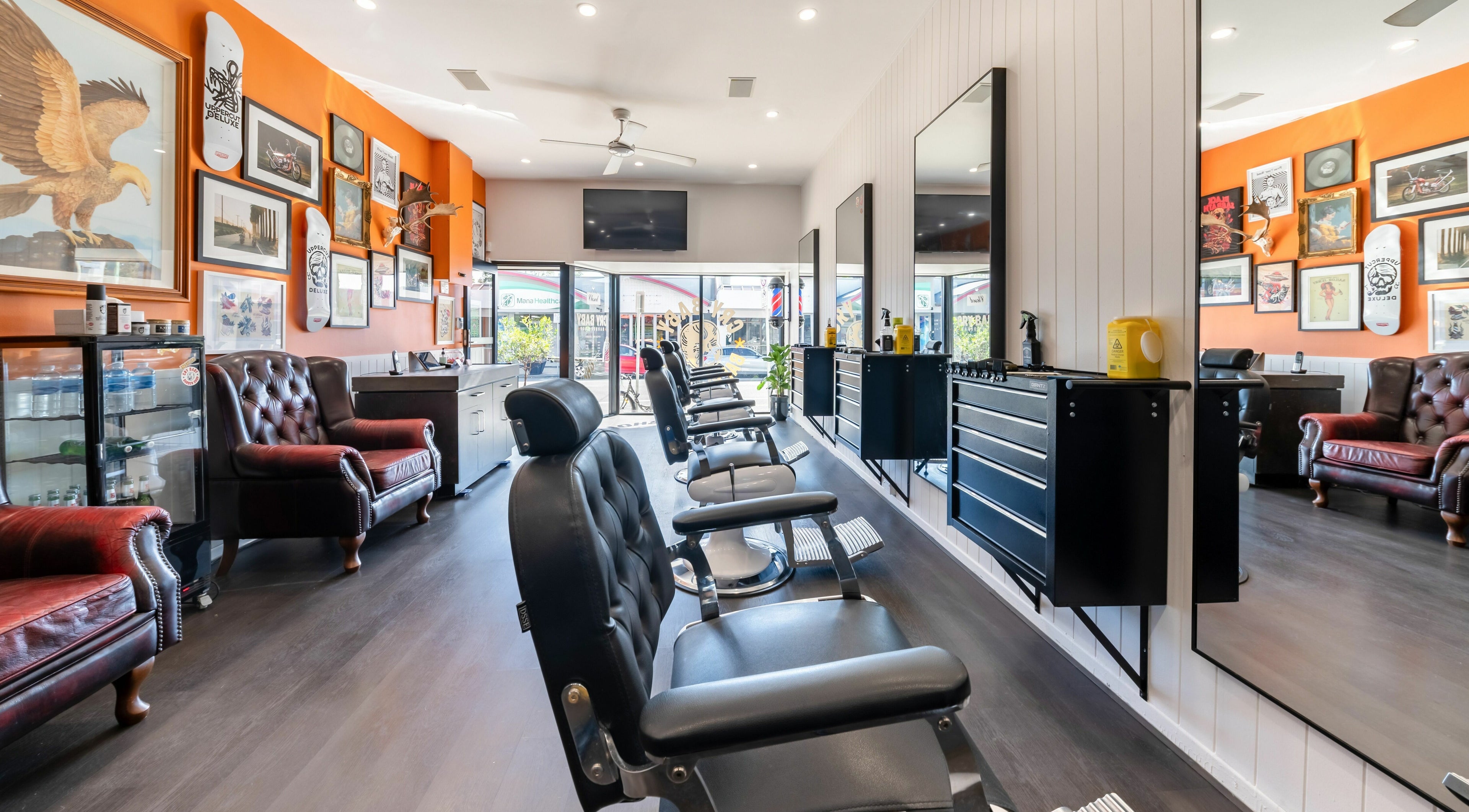 Interior view of Cry Baby Barber Shop, Southport, Queensland, AU showcasing modern barber chairs and decor.