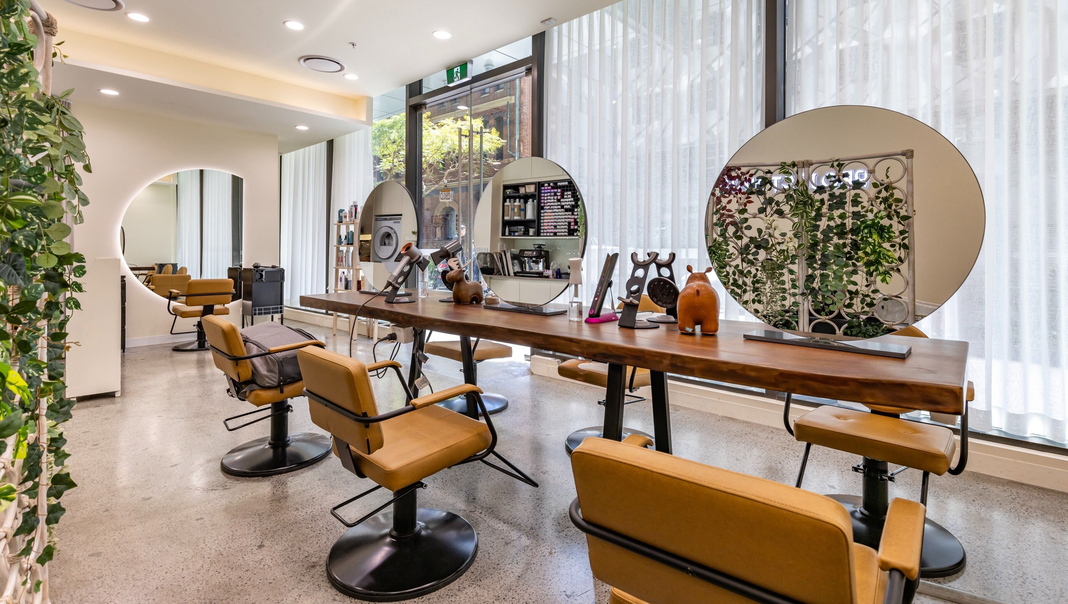 Bright, modern interior of Project Hair Salon in Chippendale, NSW, AU featuring elegant styling stations.