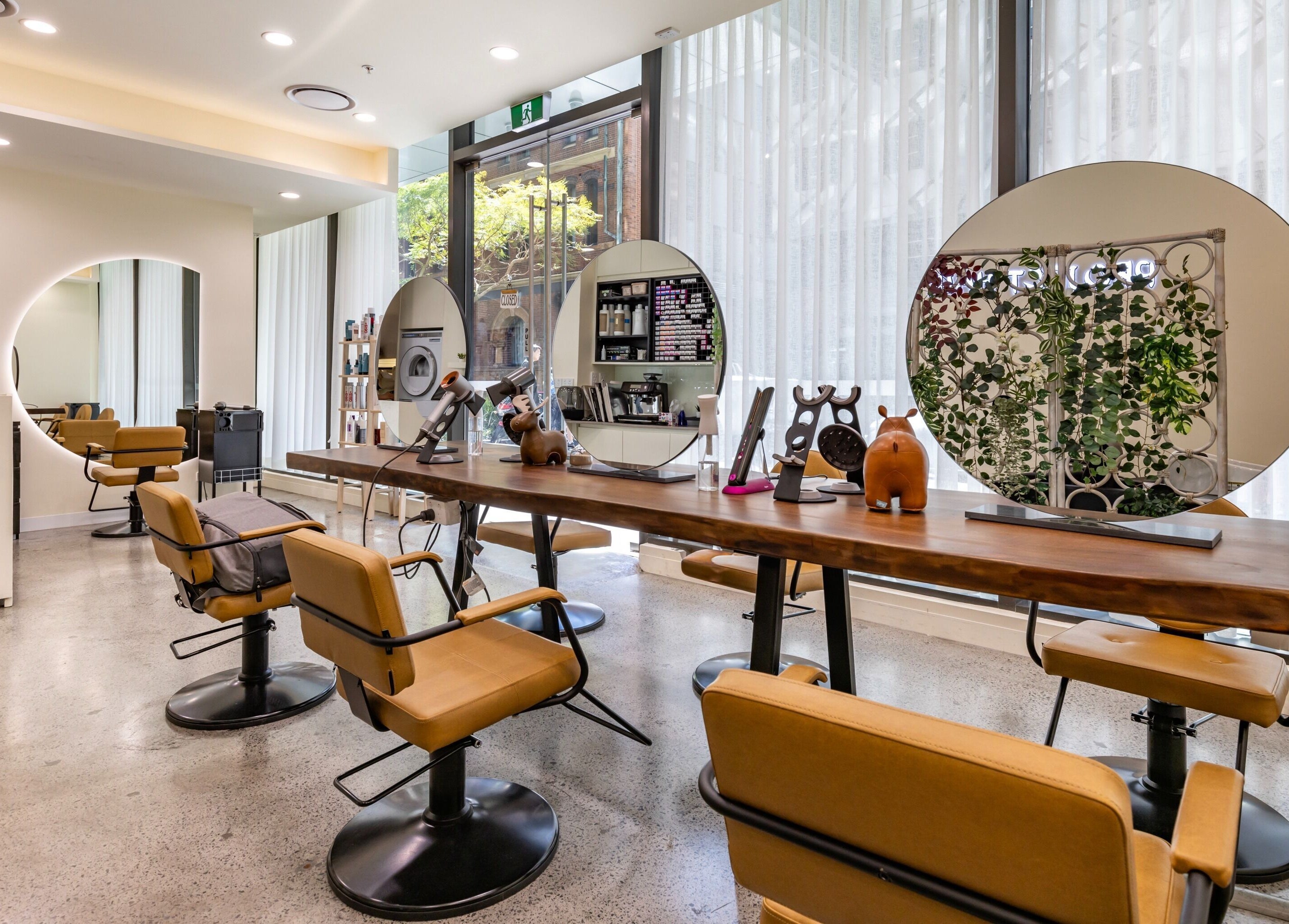 Bright, modern interior of Project Hair Salon in Chippendale, NSW, AU featuring elegant styling stations.