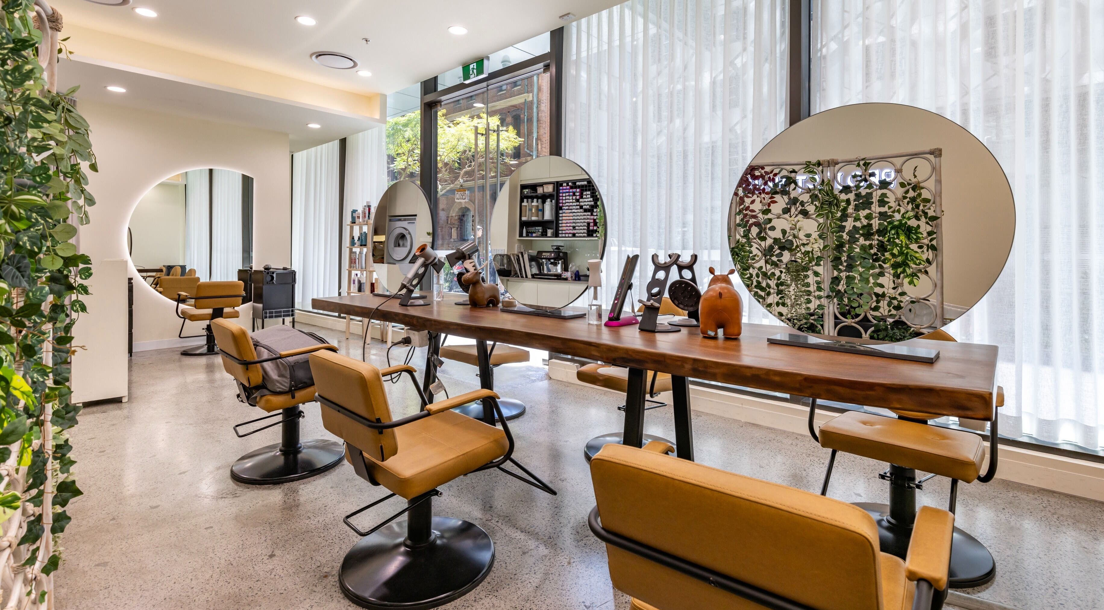 Bright, modern interior of Project Hair Salon in Chippendale, NSW, AU featuring elegant styling stations.
