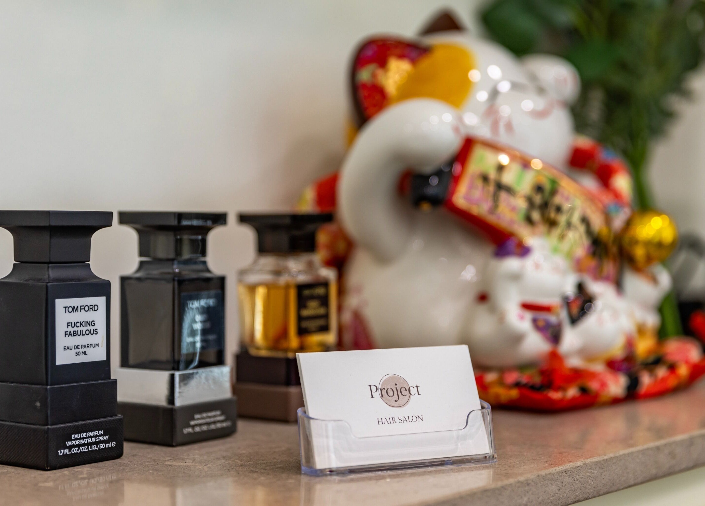 Perfume bottles and decor at Project Hair Salon, Chippendale, NSW, AU. Elegant salon aesthetics.