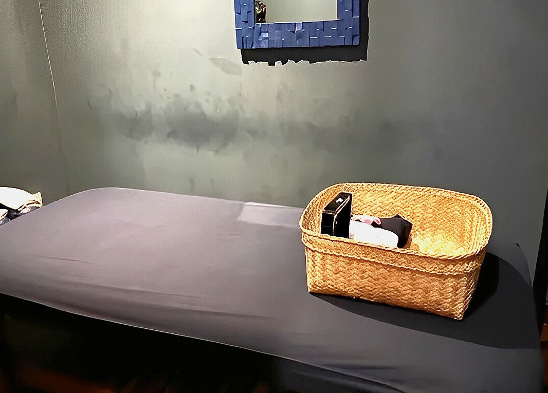 Peaceful massage room at Essential Health & Rejuvenation Spa, Bali, Bali, ID, featuring a treatment bed and basket.