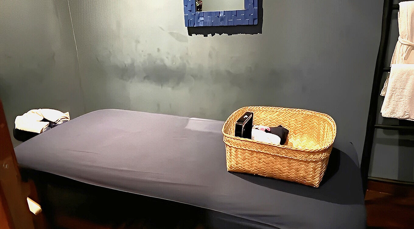 Peaceful massage room at Essential Health & Rejuvenation Spa, Bali, Bali, ID, featuring a treatment bed and basket.
